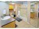 Bright bathroom with a glass-enclosed shower, tiled floors, and ample counter space at 6380 S Boston St # 191, Greenwood Village, CO 80111