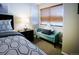 Bright bedroom featuring a cushioned bench by the window and geometric patterned bedding at 6380 S Boston St # 191, Greenwood Village, CO 80111