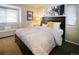 Comfortable bedroom with patterned bedding, accent pillows, and window bench seating at 6380 S Boston St # 191, Greenwood Village, CO 80111