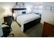 Well-lit bedroom with dark wood bed frame and blue accents, featuring bedside tables and window seating at 6380 S Boston St # 191, Greenwood Village, CO 80111