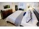 Spacious bedroom featuring a large bed with decorative pillows and a dresser with a television at 6380 S Boston St # 191, Greenwood Village, CO 80111