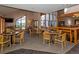 Cozy dining area with multiple tables and chairs, enhanced by natural light from large windows at 6380 S Boston St # 191, Greenwood Village, CO 80111