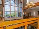Bright interior space featuring a large window with wooden railing and chandelier at 6380 S Boston St # 191, Greenwood Village, CO 80111