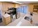 Efficient kitchen features stainless appliances, ample cabinet space, and bright countertops at 6380 S Boston St # 191, Greenwood Village, CO 80111