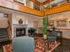 Inviting lobby area with fireplace, staircase, plants, and comfortable seating arrangement at 6380 S Boston St # 191, Greenwood Village, CO 80111