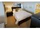 Comfortable main bedroom with a dark wood bed frame, neutral decor and wall art at 6380 S Boston St # 191, Greenwood Village, CO 80111
