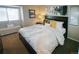 Comfortable bedroom with neutral décor, bright window and a cushioned bench seat at 6380 S Boston St # 191, Greenwood Village, CO 80111