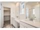 Main bathroom with double vanity and large walk-in closet at 4847 Astor Pl, Brighton, CO 80601