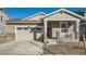 Exterior of charming craftsman style home with two-car garage and front porch at 4847 Astor Pl, Brighton, CO 80601