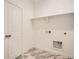 Laundry room with built-in shelving and white cabinets at 4847 Astor Pl, Brighton, CO 80601