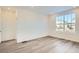 Bright and airy spare bedroom with large window and grey carpet at 4847 Astor Pl, Brighton, CO 80601