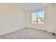 Spacious spare bedroom with large window and grey carpet at 4847 Astor Pl, Brighton, CO 80601