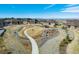 Aerial view showing the home with walking paths, benches, and open green space for outdoor activities at 25019 E Alder Dr, Aurora, CO 80016