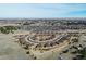 A wide aerial shows the house nestled in a friendly community with a scenic backdrop at 25019 E Alder Dr, Aurora, CO 80016