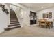 Basement with carpet, stairs, cabinetry, shelving, stainless fridge and dining area at 25019 E Alder Dr, Aurora, CO 80016