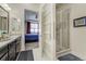 Bathroom with double vanity, glass shower, and doorway to the bedroom at 25019 E Alder Dr, Aurora, CO 80016