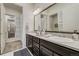 Spacious bathroom featuring dual sinks, sleek dark wood cabinets and contemporary design elements throughout the space at 25019 E Alder Dr, Aurora, CO 80016