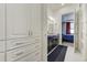 Bathroom with white cabinets, double vanity, and views of the bedroom at 25019 E Alder Dr, Aurora, CO 80016