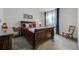 Bedroom featuring a wooden sleigh bed, gray carpet, side table and modern decor at 25019 E Alder Dr, Aurora, CO 80016