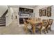 Basement dining area with kitchenette, staircase to upper level, and room for entertaining at 25019 E Alder Dr, Aurora, CO 80016