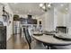 Well-lit dining area with stainless steel appliances and views into the stylish kitchen at 25019 E Alder Dr, Aurora, CO 80016