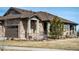 Charming home featuring a stone facade, covered porch, and well-maintained landscaping at 25019 E Alder Dr, Aurora, CO 80016