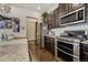 Modern kitchen with stainless steel appliances and granite countertops at 25019 E Alder Dr, Aurora, CO 80016