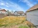 Backyard with grass area and outdoor patio. Home exterior in background at 244 S Fetzer St, Byers, CO 80103