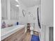 Cozy bathroom featuring tub, vanity and decorative mirror at 244 S Fetzer St, Byers, CO 80103