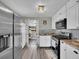 Functional kitchen boasts white cabinets, and stainless steel appliances at 244 S Fetzer St, Byers, CO 80103