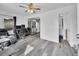 Bright living room with wood floors, chair, desk, and a modern ceiling fan at 244 S Fetzer St, Byers, CO 80103