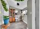 Sunroom with hardwood floors, large windows for natural light, and glass display cabinet at 244 S Fetzer St, Byers, CO 80103