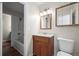 Bathroom featuring a wood vanity, tiled walls, and a shower-tub combo at 1931 Centennial Dr # 1931, Louisville, CO 80027