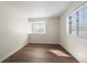 Bright bedroom with wood-look floors and natural light streaming through the windows at 1931 Centennial Dr # 1931, Louisville, CO 80027