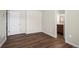 Well-lit bedroom with sleek wood-look flooring leading to an ensuite bathroom at 1931 Centennial Dr # 1931, Louisville, CO 80027