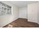 Bright bedroom with a large window, hardwood floors, closet, and neutral wall color at 1931 Centennial Dr # 1931, Louisville, CO 80027