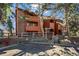 Inviting exterior of a wood-clad condo building with mature trees and well-maintained landscaping at 1931 Centennial Dr # 1931, Louisville, CO 80027