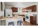 Well-equipped kitchen with wooden cabinets, sleek appliances, and a breakfast bar with seating at 1931 Centennial Dr # 1931, Louisville, CO 80027