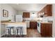 Charming kitchen featuring wooden cabinets, modern appliances, and a breakfast bar for casual dining at 1931 Centennial Dr # 1931, Louisville, CO 80027