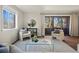 Bright living room featuring comfortable seating, hardwood floors, and natural light from large window at 1931 Centennial Dr # 1931, Louisville, CO 80027