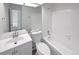 Clean bathroom with a single sink, toilet, and bathtub at 4578 Malta St, Denver, CO 80249