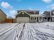 Two-story house with attached garage, snowy front yard, and a charming porch at 4578 Malta St, Denver, CO 80249