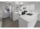Kitchen with white cabinets, stainless steel appliances, and an island at 4578 Malta St, Denver, CO 80249