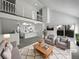 Spacious living room with vaulted ceilings, and a view into the kitchen at 4578 Malta St, Denver, CO 80249
