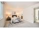 Inviting bedroom with neutral palette, area rug and a glimpse of ensuite bathroom at 13093 W Cedar Dr # 121, Lakewood, CO 80228