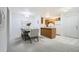 Well-lit dining space adjoining a functional kitchen with modern lighting and flooring at 13093 W Cedar Dr # 121, Lakewood, CO 80228