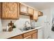 Kitchen sink and counter space with appliances and wood cabinets at 13093 W Cedar Dr # 121, Lakewood, CO 80228