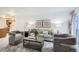 Comfortable living room showcasing neutral decor, a couch, and access to outdoor balcony at 13093 W Cedar Dr # 121, Lakewood, CO 80228