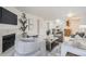 Open-concept living room leading to kitchen and dining area with fireplace and neutral decor at 13093 W Cedar Dr # 121, Lakewood, CO 80228