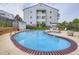 Inviting community pool and hot tub surrounded by fencing and lounge chairs at 13093 W Cedar Dr # 121, Lakewood, CO 80228